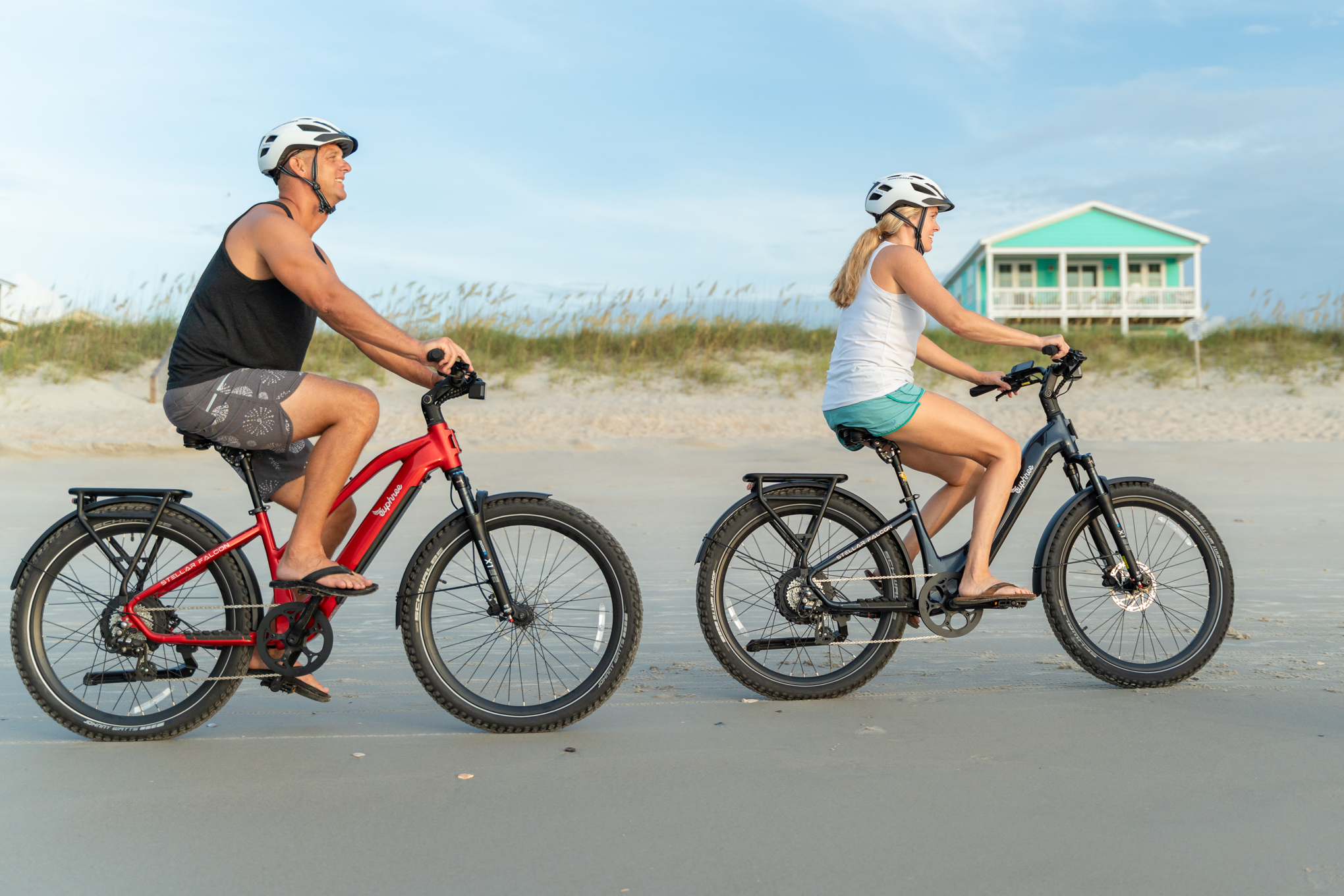 couple riding on beach